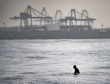 High contrast of unrecognizable surfer waitingの写真素材