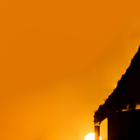 Tube with black smoke and huge sun with text spaceの写真素材