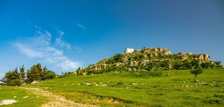 Chapel on top of the hill under blue skyの写真素材