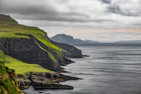 Steep coastline of Mykines island, Faroe Islandsの写真素材