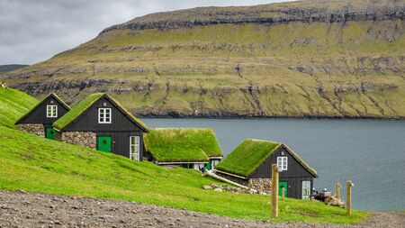 Faroe Islands wooden houses with grass on the roofの写真素材