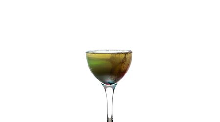 A cup with colorful liquid on whiteの写真素材