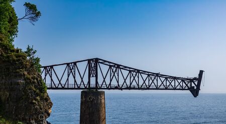 Old rusty abandoned iron loading bay in the oceanの写真素材