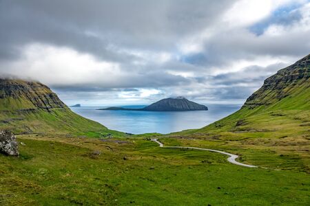 Road down to the ocean with islands in the backgroundの写真素材