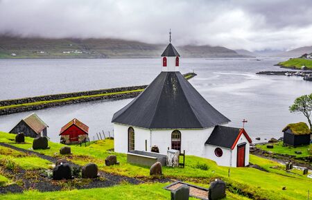 Round church and graveyard in Faroe Islandsの写真素材