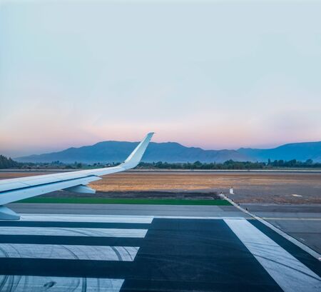 Jet wing prepared for takeoff on runwayの写真素材