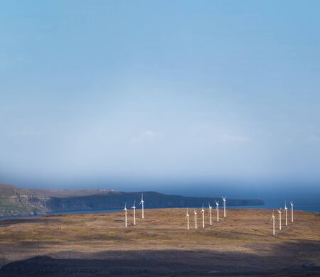Windmill farm on top of the mountain near the oceanの写真素材