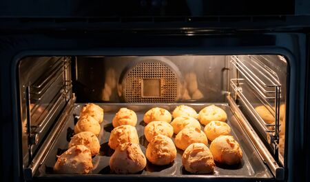 Preparing many cheese breads in home ovenの写真素材