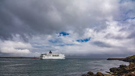Huge cruise ship leaving the port under the cloudsの写真素材