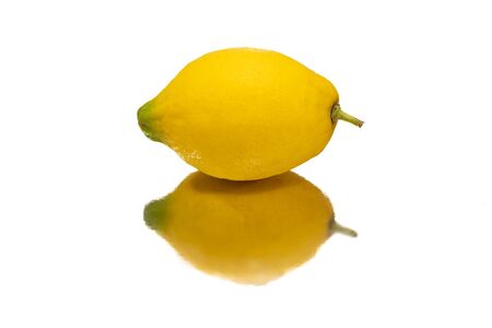 Yyellow lemon isolated on white and reflectedの写真素材