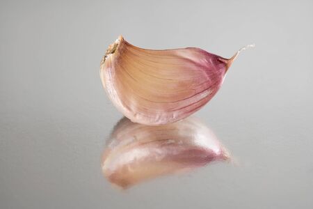 A clove of garlic reflected closeup macroの写真素材