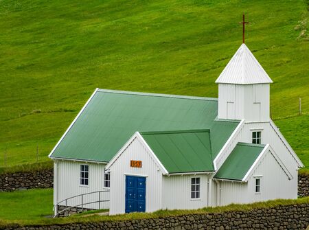 Beautiful nordic church with green roof in Faroe Islandsの写真素材