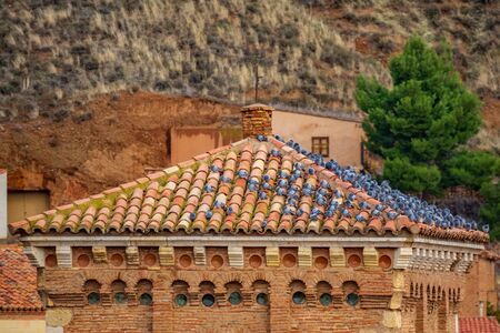 Tower tile roof with large group of pigeonsの写真素材