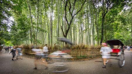 Path to bamboo forest with blurred tourists in Arashiyama, Kyotoの写真素材