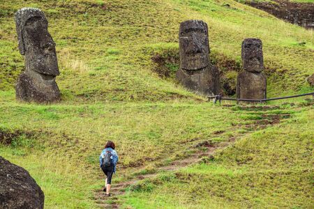 Unrecognizable tourist walking between moais, Easter Islandの写真素材