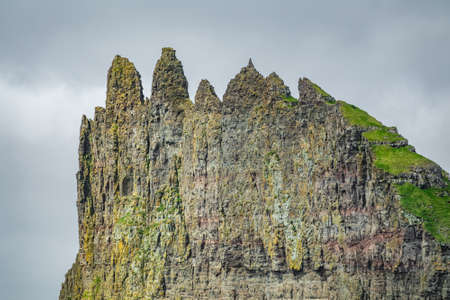 Sharp cliff with diferent peaks under the skyの写真素材