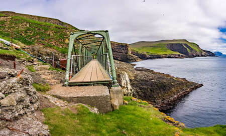 Suspension bridge in Mykines island connecting islandsの写真素材