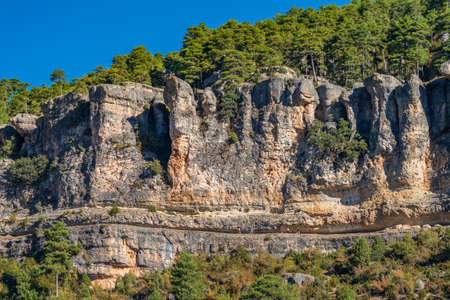 Spectacular trekking route under the rocks with touristsの写真素材