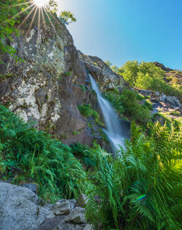 Waterfall in Sanabria with sunstar over the rocksの写真素材