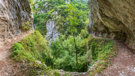 Las Xanas gorge with unrecognizable tourists hikingの写真素材