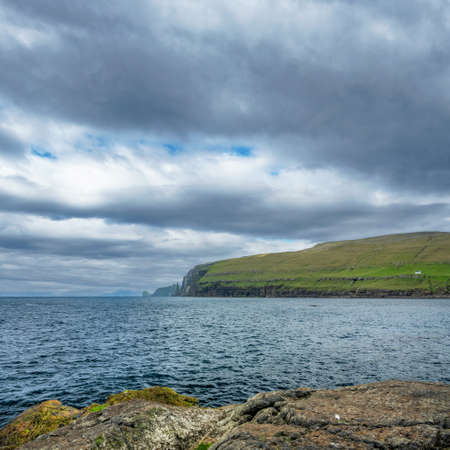Steep coastline of Faroe Islands with sharp rocksの写真素材