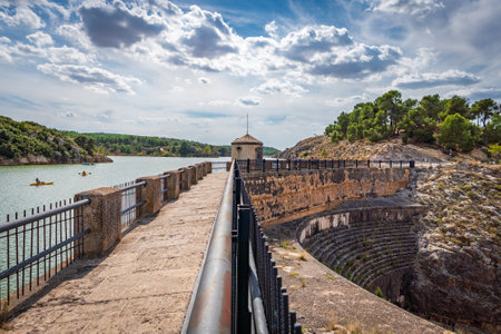 Antique dam with tourists and canoeists, wide angleの写真素材