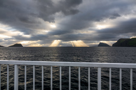 Dark sunset with ray lights from large ship railの写真素材