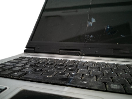 Old ruined laptop closeup view with dirty keyboardの写真素材