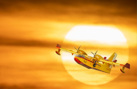 Hydroplane flying over huge sun in the backgroundの写真素材