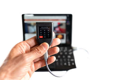 Digital wallet asking for pin with laptop in the backgroundの写真素材