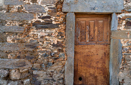 Old run-down wooden door with slate jambの写真素材