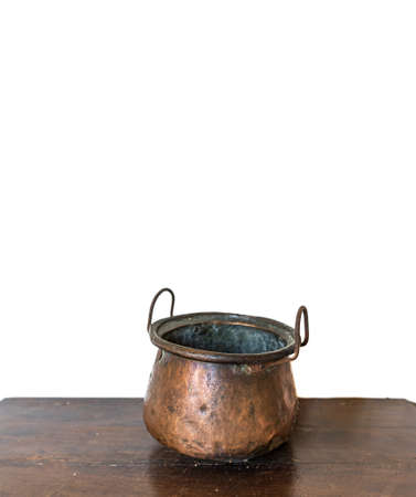 Antique copper pot over the table and white backgroundの写真素材