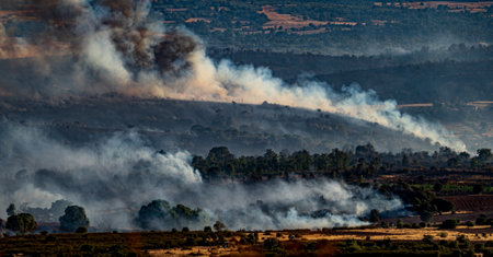Devastated field with smoke trails during the fireの写真素材