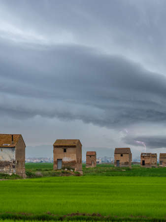 Rice fields and farms under the stormの写真素材