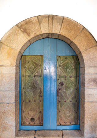 Antique church door with stone arch, front viewの写真素材