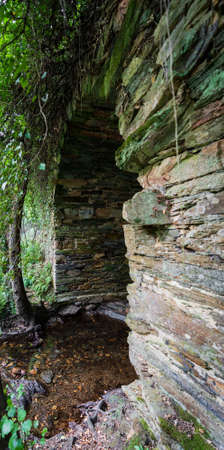 Stream and old stone bridge in the middle of the forestの写真素材