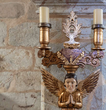 Ornamented candelabra closeup with angel and candlesの写真素材