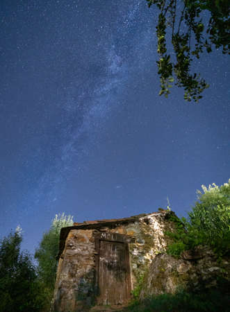 Old stone house under the milky wayの写真素材