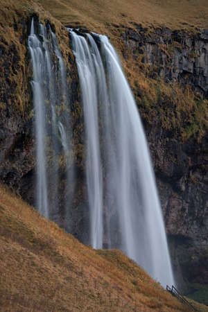 Seljalandfoss Waterfall in Iceland long exposure with hiking pathの写真素材
