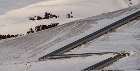 Aluminium pipes over the snow covered mountainの写真素材