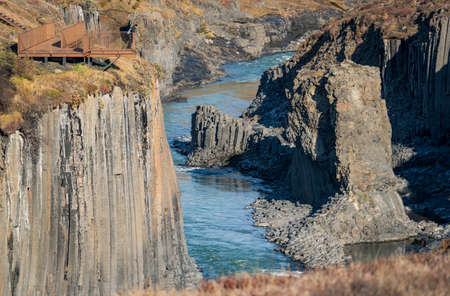 Studlagil basalt canyon long shot viewpoint with blurred tourist, Icelandの写真素材