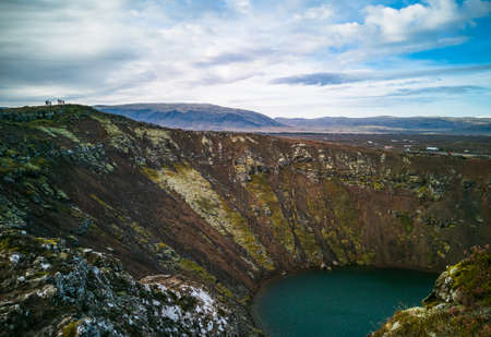 Kerid crater with tourists silhouette in Icelandの写真素材