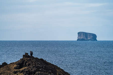 Tourists over the hill looking at the isletの写真素材