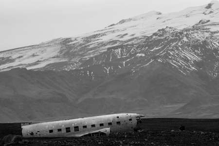 Wreck of and airplane profile and mountainsの写真素材