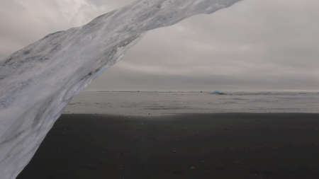Large Iceberg over diamond beach in Jokulsarlonの写真素材
