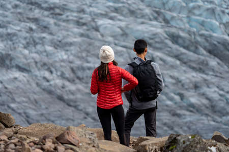 Unrecognizable tourist couple looking to the glacierの写真素材