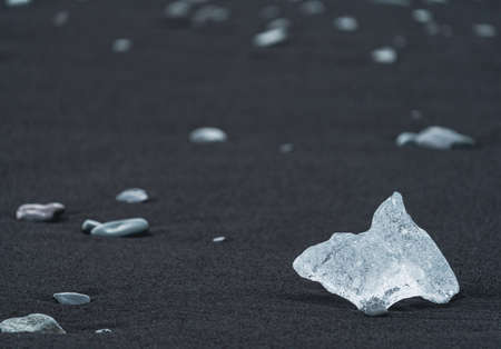 Ice diamond over the black sand of diamonds beach in Jokulsarlonの写真素材