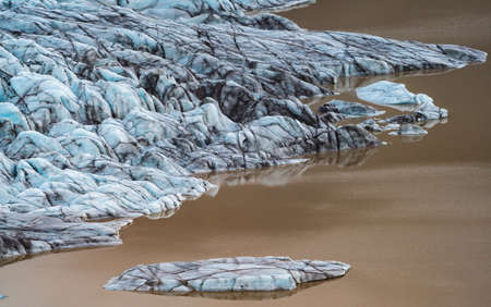 Spectacular glacier tongue end over golden lakeの写真素材