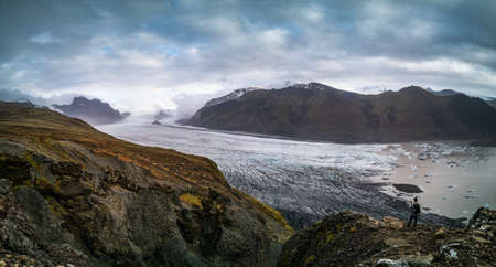 Tourist on top of spectacular viewpoint to glacierの写真素材