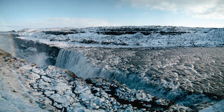 Massive Dettifoss waterfall on winter covered by snowの写真素材